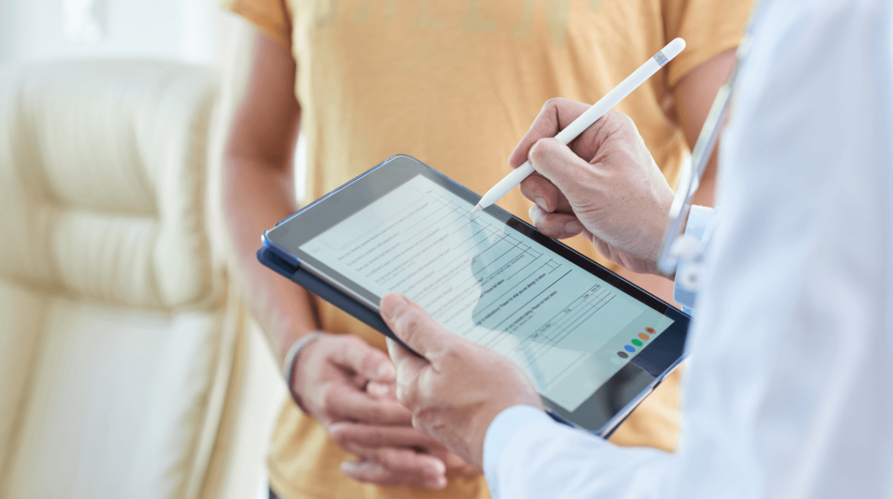 Doctor writing on electronic tablet